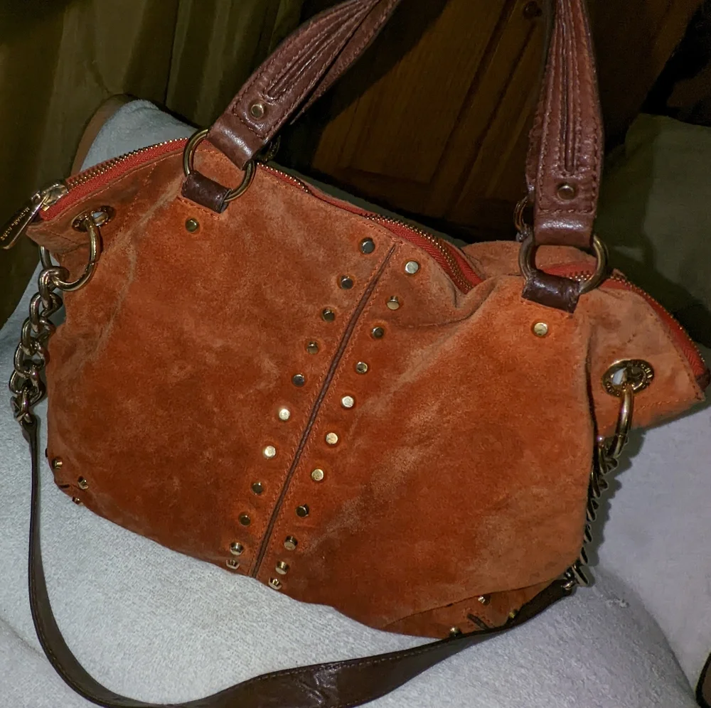 Michael Kors orange suede studded slouchy shoulder bag.